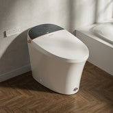 Modern white toilet in a bathroom setting with dark tiled walls.